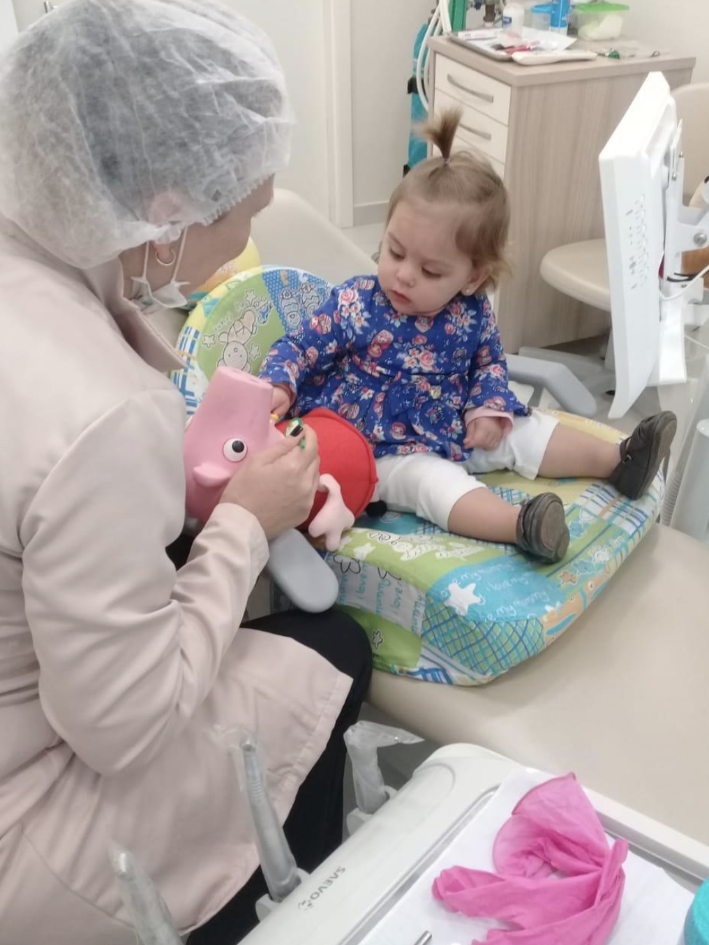 Bebê acolhida no consultório durante atendimento lúdico